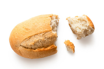 Broken white french bread roll isolated on white. Top view.