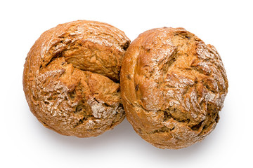 Two round rustic whole wheat bread rolls isolated on white. Top view.