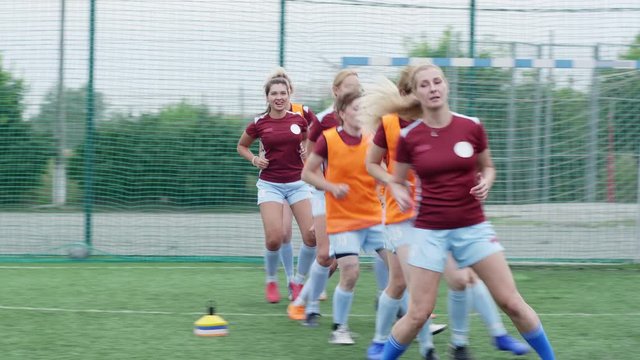 Soccer players warming up legs before match, doing sidestep
