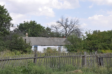 old abandoned house behind the fence