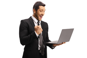 Happy professional man gesturing and looking at a laptop computer