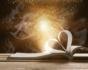 Open book on wooden table, education and learning concept