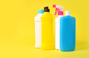 Set of plastic bottles on a yellow background