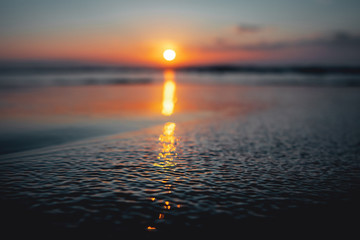 Beautiful sunset ocean view with waves and reflection. Praia da Bordeira at the Algarve Coast in Portugal, Atlantic Ocean