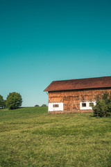 Fototapeta na wymiar Bavarian scenery with a barn in the fields