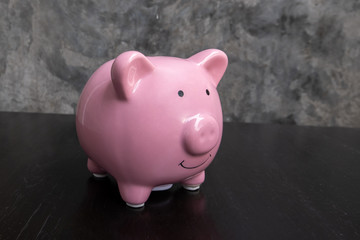 Pink piggy bank on black background, step up growing business to success and saving for retirement  concept
