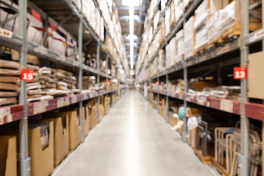 blurred brown goods boxes on full shelves in warehouse storage factory . perspective background with space for business about logistics shipping and commercial concept .