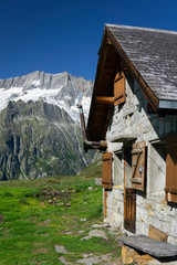 Swiss Mountain Hut in Front of Glaciated Mountain