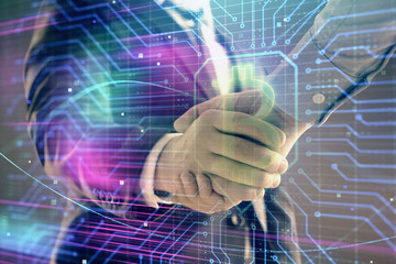 Multi exposure of bitcoin sign on abstract background with two men handshake. Concept of cryptocurrency