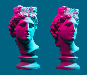 Statue neon. On a blue isolated background. Gypsum statue of Apollo's head. Man.