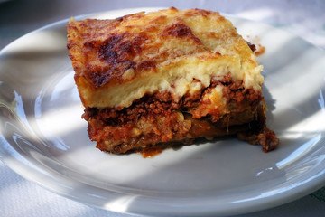 moussaka with aubergine on a dish. traditional greek meal on a table