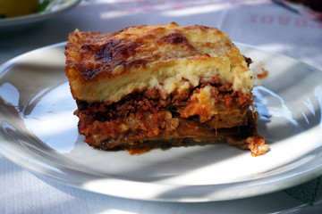 moussaka with aubergine on a dish. traditional greek meal on a table
