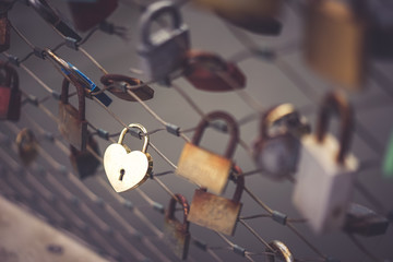 Lock for couple for making a promise to love forever. Master keys hanging on the rails of bridge,...