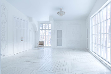 A spacious bright living room with a stylish modern design with elements of antique decor and beautiful chic furniture