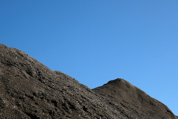Barren mountain ridge and blue sky background