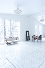 A spacious bright living room with a stylish modern design with elements of antique decor and beautiful chic furniture