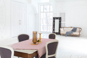 A spacious bright living room with a stylish modern design with elements of antique decor and beautiful chic furniture