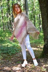 Yuomg woman in knitted poncho, Model for knitting, Handmade, Forest background