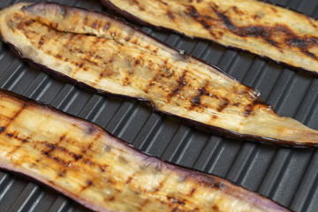 Grilled eggplant on electric bbq, top view. Vegetarian course of aubergine.