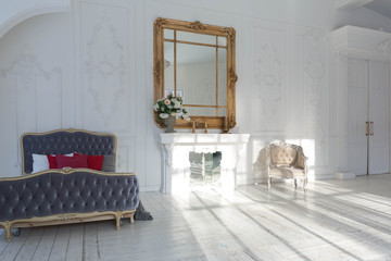 A spacious bright living room with a stylish modern design with elements of antique decor and beautiful chic furniture