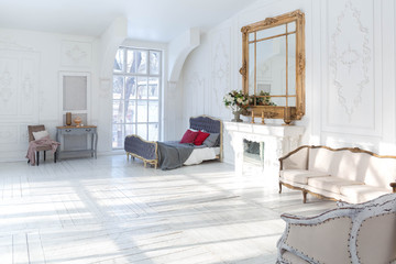 A spacious bright living room with a stylish modern design with elements of antique decor and beautiful chic furniture