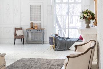 A spacious bright living room with a stylish modern design with elements of antique decor and...