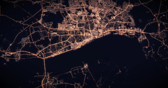 Aerial night view of city of Kingston upon Hull. Traffic and street light glowing. Camera flying high above, moving slowly forward from space filming cinematic straight down. 3d animation rendering.