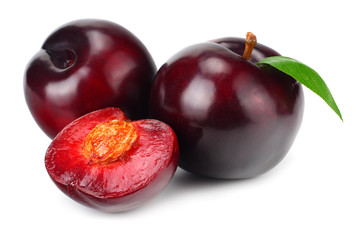 fresh plum fruit with green leaf and cut plum slices isolated on white background