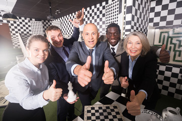 Happy businesspeople in black and white quest room
