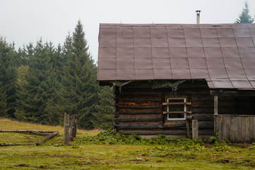 Old house in the mountains. Fog. Dawn. Gicha mountain meadow. Carpathians