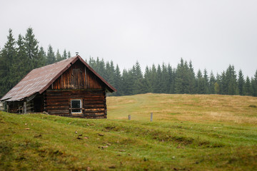 Old house in the mountains. Fog. Dawn. Gicha mountain meadow. Carpathians