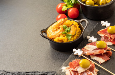Spanish tapas, Iberian ham, Valencian paella and olives