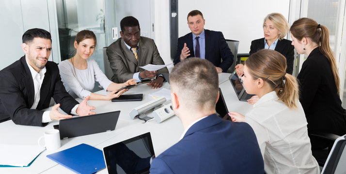 Multinational team of confident business partners discussing