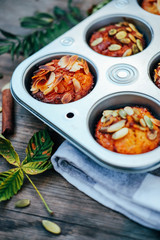 Healthy fall vegetarian dessert. Apple cupcake with pumpkin, almond seeds and spices.