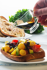 Bruschetta with avocado, tomatoes and  basil with balsam sauce. Close up. Selective focus.