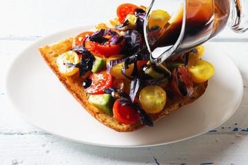 Bruschetta with avocado, tomatoes and  basil with balsam sauce. Close up. Selective focus.