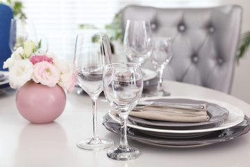 Beautiful table setting in modern dining room interior