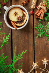 Obraz na płótnie Canvas Christmas mulled wine on a wooden table. Traditional hot drink at Christmas (red wine with spices, New Year's Eve, Noel holiday festive) x-mas flat lay. food background. copy space. Top viev