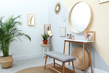 Stylish room interior with little table and comfortable bench