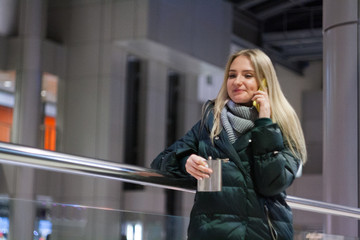 beautiful young woman in the shopping centre using smartphone
