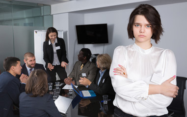 Fototapeta na wymiar Portrait of upset young woman in boardroom