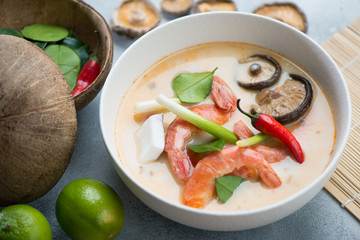Tom Yum soup with shrimps served in a white bowl, studio shot, selective focus