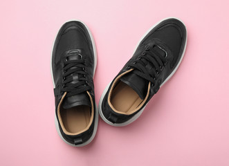Pair of stylish shoes on pink background, top view