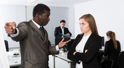 Angry boss dismissing frustrated female
