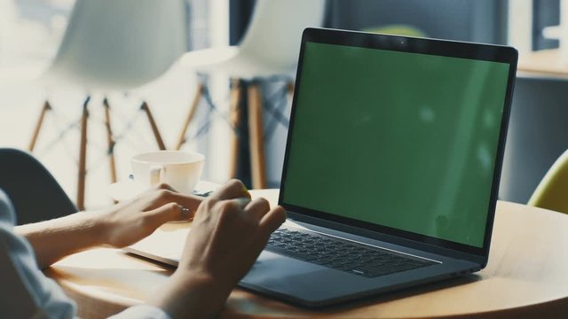 woman hands using touchpad on chromakey screened computer