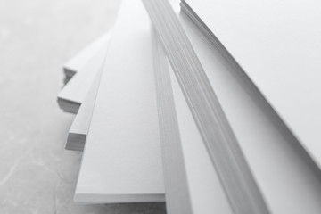 Stack of blank white paper on marble table, closeup