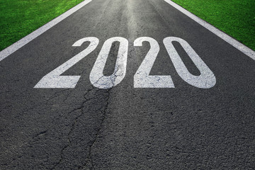 Conceptual business entering new year 2020 on sunny asphalt road.