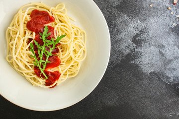 pasta spaghetti with tomato sauce (delicious gourmet dish, classic combination of taste, Italian cuisine) menu concept. food background. copy space. Top viev