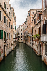 Fototapeta na wymiar The dark waters of The Venetian canal