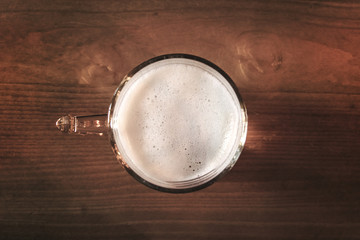 top view of glass of beer on rustic table, it is one of the oldest and most widely consumed alcoholic drinks in the world